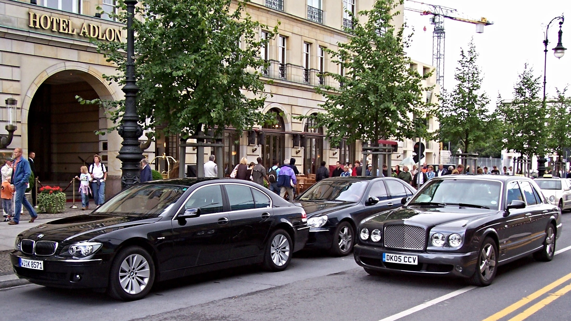 German luxury cars parked along a street